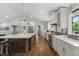 Bright, open kitchen with a large island, stainless steel appliances, and hardwood floors at 2717 S Langley Ct, Denver, CO 80210