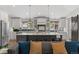 Modern kitchen with sleek white cabinets, a large island, and stainless steel appliances at 2717 S Langley Ct, Denver, CO 80210