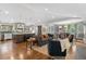 Bright, open-concept living room features hardwood floors and modern furnishings at 2717 S Langley Ct, Denver, CO 80210