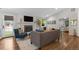 Bright and airy living room with a fireplace, TV, neutral-toned sofa, hardwood floors, and lots of light at 2717 S Langley Ct, Denver, CO 80210