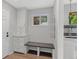 Functional mud room with built-in storage, a bench, and access to the laundry area, perfect for organization at 2717 S Langley Ct, Denver, CO 80210