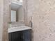 Charming powder room with floral wallpaper, stylish vanity, and modern lighting at 2717 S Langley Ct, Denver, CO 80210