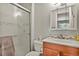 Updated bathroom features tiled shower with glass doors and stylish vanity at 2557 S Dover St # 12, Lakewood, CO 80227