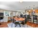 Open-concept dining area featuring hardwood floors and seamless integration with living room and kitchen at 2557 S Dover St # 12, Lakewood, CO 80227