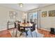Charming dining room featuring a round table, modern decor, and a sliding door to the backyard at 2557 S Dover St # 12, Lakewood, CO 80227