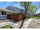 Exterior shot of house shows the deck and yard at 2557 S Dover St # 12, Lakewood, CO 80227