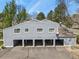 A row of townhomes, each with its own car port, with a grey exterior and a well-maintained appearance at 2557 S Dover St # 12, Lakewood, CO 80227
