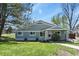 Charming single-story home with blue siding, manicured lawn, and front yard landscaping at 2557 S Dover St # 12, Lakewood, CO 80227