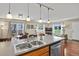 Bright, modern kitchen with stainless steel appliances and a seamless transition to the dining and living area at 2557 S Dover St # 12, Lakewood, CO 80227