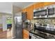 Modern kitchen with stainless steel appliances, mosaic backsplash, and ample natural light at 2557 S Dover St # 12, Lakewood, CO 80227