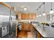Modern kitchen featuring stainless steel appliances, stylish backsplash, and dark countertops at 2557 S Dover St # 12, Lakewood, CO 80227