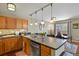 Kitchen with stainless steel appliances, dark countertops, and a view into the dining area at 2557 S Dover St # 12, Lakewood, CO 80227