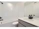 Bright bathroom featuring a white subway tiled shower over tub and a modern vanity with black fixtures at 352 N. Geneva St, Aurora, CO 80010