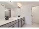 Modern bathroom featuring double vanity with sleek fixtures and a glass-enclosed shower, providing a clean and stylish look at 352 N. Geneva St, Aurora, CO 80010