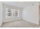 Well-lit bedroom with neutral carpet and a large window, offering a bright and inviting space at 352 N. Geneva St, Aurora, CO 80010