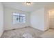 Clean bedroom with neutral carpet and a large window, offering a simple and inviting space at 352 N. Geneva St, Aurora, CO 80010