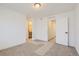 Bright bedroom featuring neutral carpet, ample closet space, and access to a private bathroom, offering comfort and convenience at 352 N. Geneva St, Aurora, CO 80010