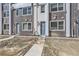 Multi-story townhouse with a mix of brick and stone facade, showcasing a contemporary design and individual entryways at 352 N. Geneva St, Aurora, CO 80010