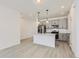 Well-lit kitchen with a center island, stainless steel appliances, and gray cabinets, creating an open and airy atmosphere at 352 N. Geneva St, Aurora, CO 80010