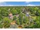 This aerial view shows a neighborhood with mature trees, well-maintained homes, sheds, and landscaping at 14797 E Temple Dr, Aurora, CO 80015