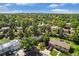 An aerial view of a residential neighborhood featuring mature trees, well-kept lawns, and solar panels at 14797 E Temple Dr, Aurora, CO 80015