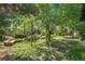The spacious backyard has lush green grass, mature trees, rock gardens, and plenty of shade at 14797 E Temple Dr, Aurora, CO 80015