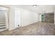 Basement with stairs, door, vinyl flooring, and a decorative wood accent wall at 14797 E Temple Dr, Aurora, CO 80015