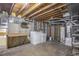 The unfinished basement provides potential for storage or finishing with included laundry, electrical, and plumbing at 14797 E Temple Dr, Aurora, CO 80015