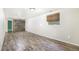 Spacious basement with modern vinyl floors, whitewashed walls and decorative wood accent wall at 14797 E Temple Dr, Aurora, CO 80015