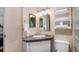Well-lit bathroom features a unique stone sink, vanity, and decorative mirror at 14797 E Temple Dr, Aurora, CO 80015