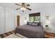 Cozy bedroom boasts a ceiling fan, natural light, and a well-made bed at 14797 E Temple Dr, Aurora, CO 80015