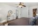 Comfortable bedroom with a ceiling fan, wooden floor, and neutral bedding at 14797 E Temple Dr, Aurora, CO 80015