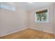 A quaint bedroom with bamboo flooring and a window with a natural view at 14797 E Temple Dr, Aurora, CO 80015