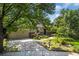Charming single-story home has a two-car garage, with mature trees, and a beautifully manicured front lawn at 14797 E Temple Dr, Aurora, CO 80015
