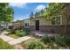 Cozy one-story home with manicured front yard landscaping and brick accents on the entrance and the side at 14797 E Temple Dr, Aurora, CO 80015