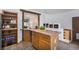 Charming kitchen with wooden cabinets, a view to the living room, and tiled floor at 14797 E Temple Dr, Aurora, CO 80015