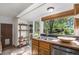 Stainless steel sink with a window that overlooks the back yard of this home at 14797 E Temple Dr, Aurora, CO 80015
