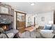 Open living room features a wood-burning brick fireplace and an open doorway to the kitchen at 14797 E Temple Dr, Aurora, CO 80015