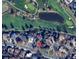 An aerial view shows the property's location on Quivas Way next to a golf course and a pond at 11351 Quivas Way, Denver, CO 80234