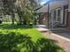 Charming brick home with lush green lawn and covered patio, perfect for outdoor relaxation and entertaining at 11351 Quivas Way, Denver, CO 80234