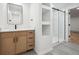 Bright bathroom featuring a modern vanity with black hardware and a glass-enclosed shower at 11351 Quivas Way, Denver, CO 80234