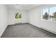 A bright bedroom features gray carpet, white walls and trim, plus natural light from the window at 11351 Quivas Way, Denver, CO 80234