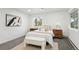 Well-lit bedroom with modern décor, carpet, and natural light from outside at 11351 Quivas Way, Denver, CO 80234