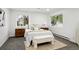 Bright bedroom featuring carpet, ensuite windows, and modern decor at 11351 Quivas Way, Denver, CO 80234