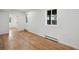 Bright bedroom with natural light featuring wood flooring and fresh, white walls at 11351 Quivas Way, Denver, CO 80234