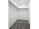 Walk-in closet has gray carpet, overhead lighting, and built-in hanging storage at 11351 Quivas Way, Denver, CO 80234