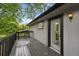 A gray wood deck offers a view from the second story and a doorway into an upstairs bathroom at 11351 Quivas Way, Denver, CO 80234