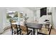 Elegant dining area features a large bay window, wood floors, and modern decor at 11351 Quivas Way, Denver, CO 80234