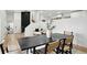 Bright dining room with black brick accent wall, a dining table, chair set, and a stylish staircase nearby at 11351 Quivas Way, Denver, CO 80234