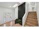 Bright entryway showcasing wood floors, a brick accent wall with plants, and modern finishes at 11351 Quivas Way, Denver, CO 80234